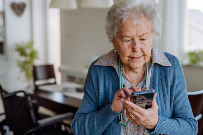 Mujer mayor interactuando con su dispositivo móvil